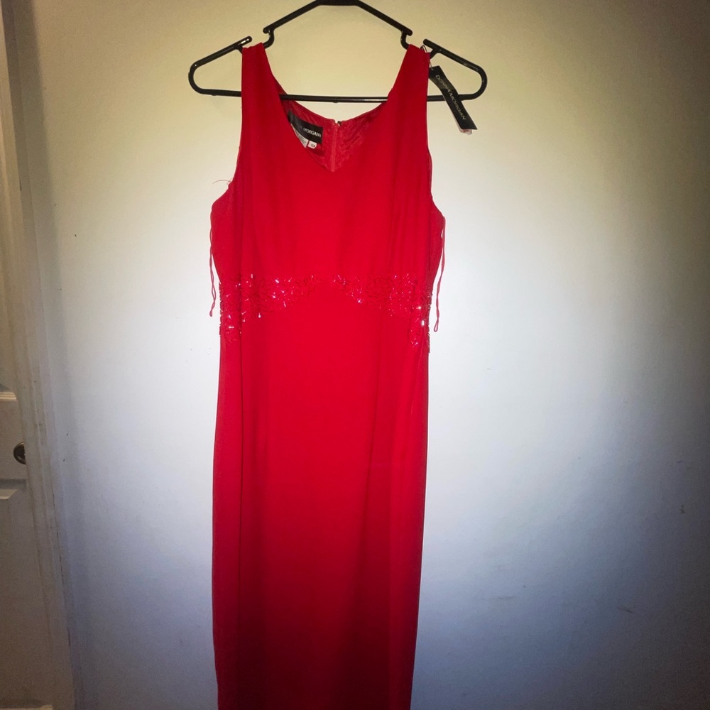 Long red dress with sprinkling beaded detailing around waist.
